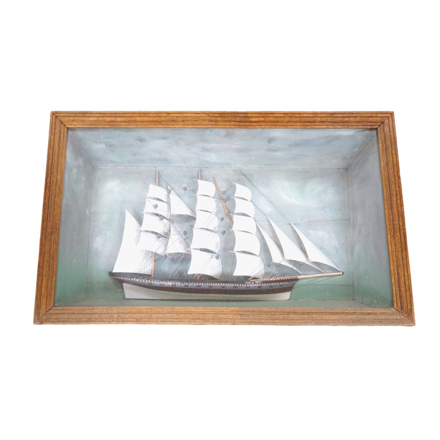 An early 20th century diorama of a ship in full sail, 70cm wide. Condition - fair